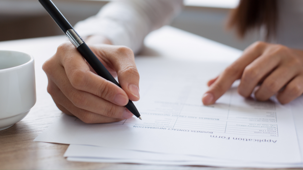 Close up of a woman writing a CV